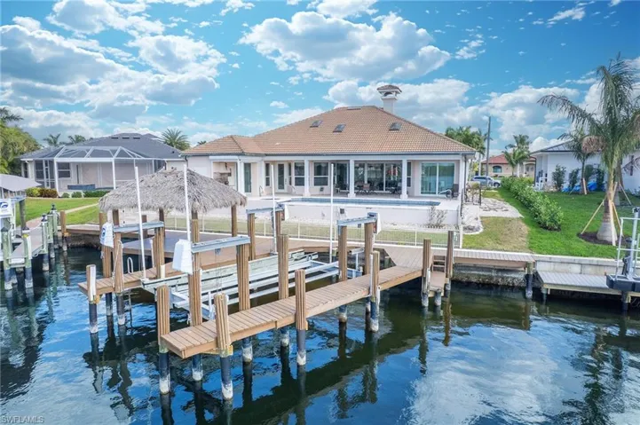 Dock area with boat lift and a water view