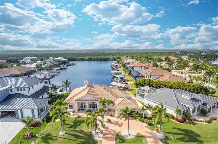Aerial perspective of suburban area featuring a large body of water
