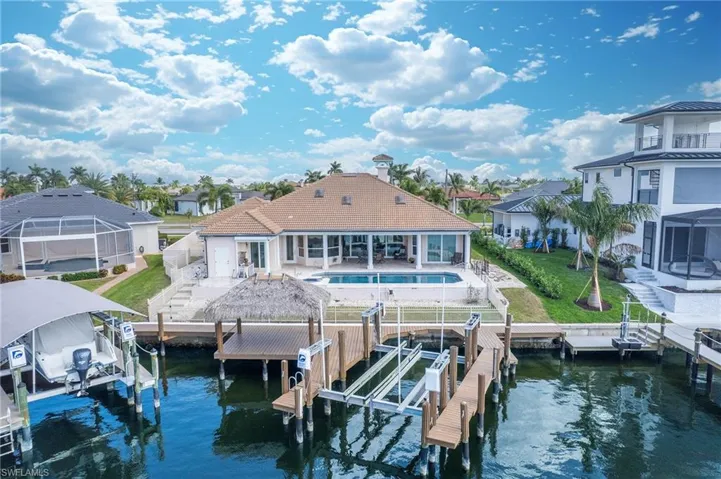 Dock featuring a patio area, boat lift, and a water view
