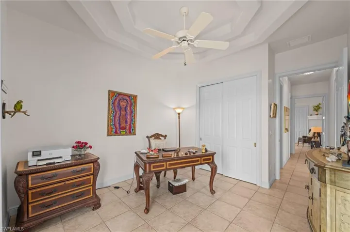 Office with light tile patterned floors and a ceiling fan