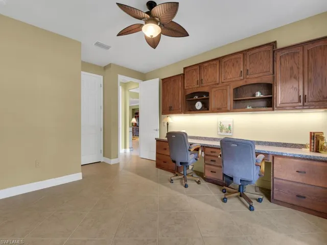 Bedroom 2 Suite / Home Office w/ built-in double desk, file cabinets, roll out keyboard trays, under cabinet lighting, & storage cabinets above.