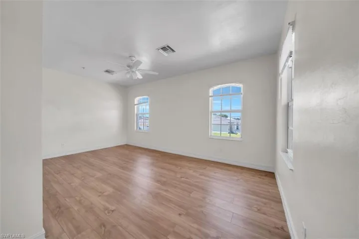 Spare room featuring light wood-type flooring and a ceiling fan