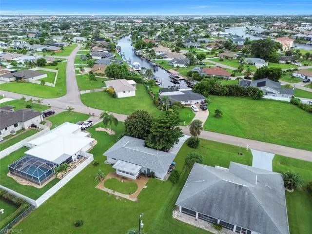 Aerial perspective of suburban area featuring a nearby body of water