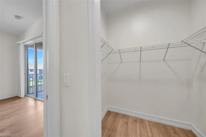 Spacious closet featuring light wood-style floors