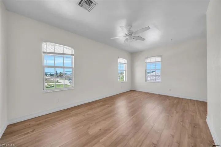 Empty room with light wood-style flooring and a ceiling fan