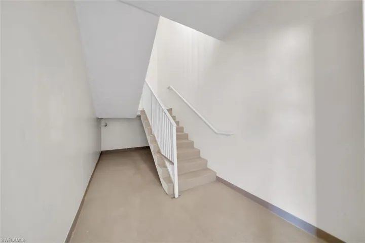 Staircase featuring baseboards