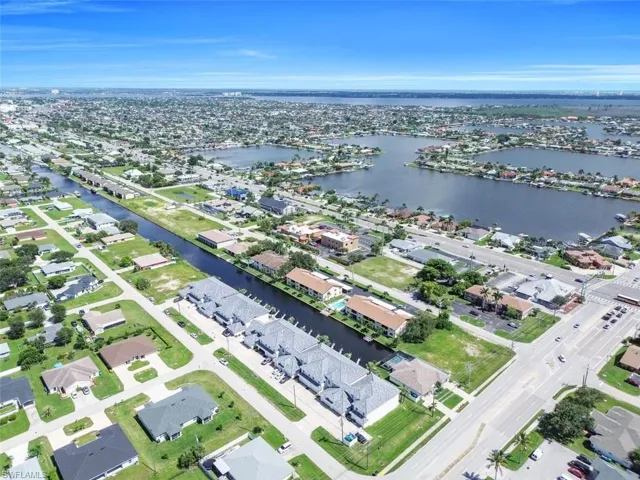 Aerial overview of property's location with nearby suburban area and a large body of water