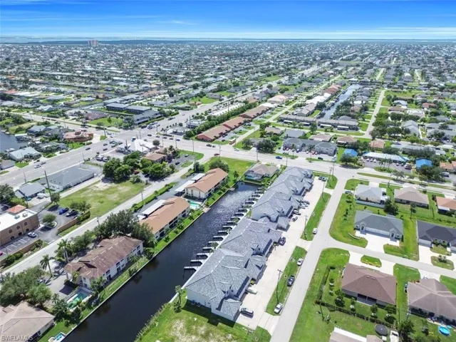 View of property location featuring a nearby body of water and nearby suburban area