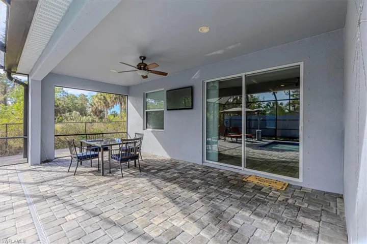View of patio with outdoor dining space and ceiling fan