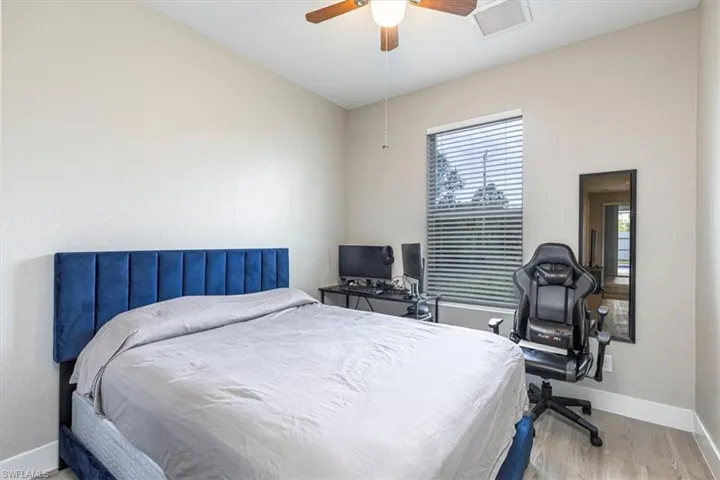 Bedroom with ceiling fan and light wood-type flooring