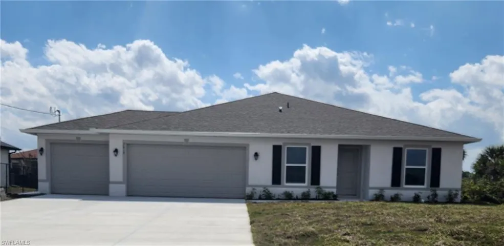 Ranch-style home with a garage, concrete driveway, a front yard, and roof with shingles
