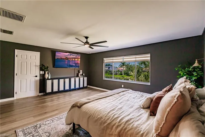Bedroom featuring ceiling fan and wood-type flooring