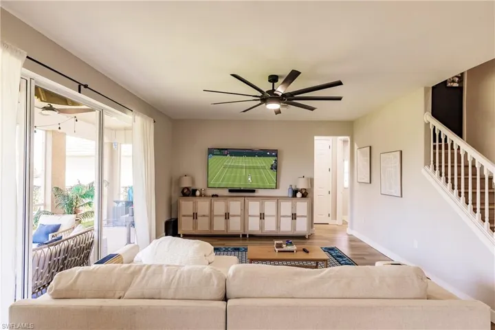 Living room with hardwood / wood-style floors and ceiling fan