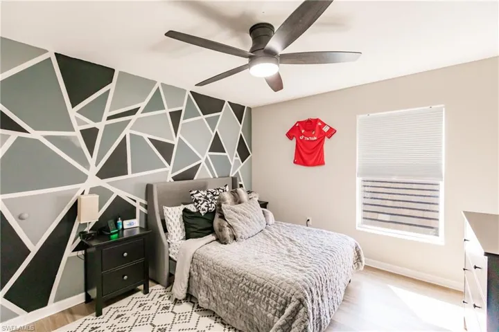 Bedroom featuring hardwood / wood-style flooring and ceiling fan