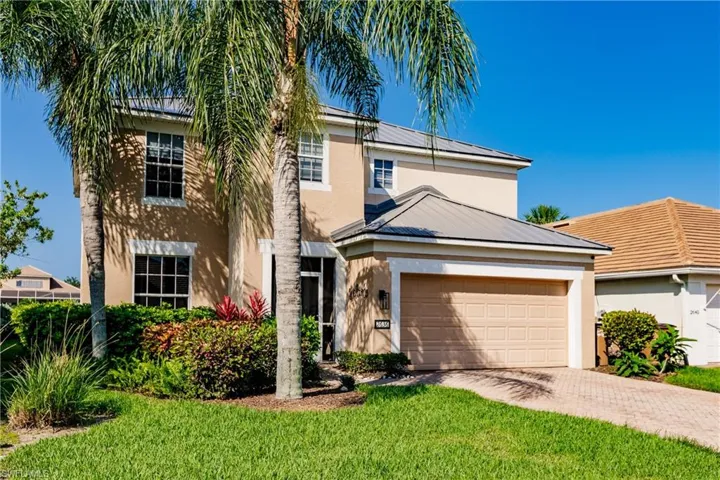 View of front of property with a garage and a front yard