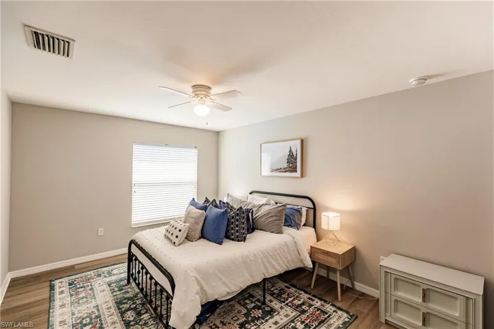 Bedroom featuring ceiling fan and hardwood / wood-style floors