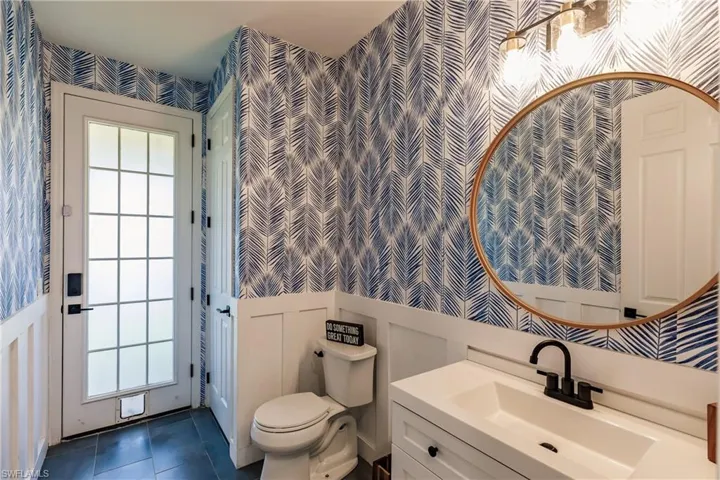 Bathroom with plenty of natural light, vanity, and toilet