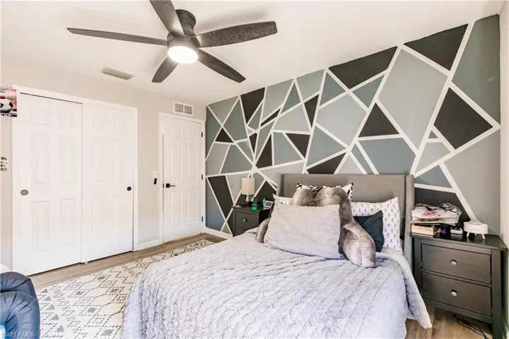 Bedroom featuring a closet, ceiling fan, and light hardwood / wood-style floors