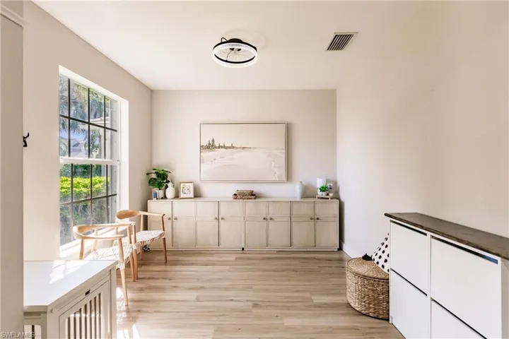 Living area with a wealth of natural light and light wood-type flooring