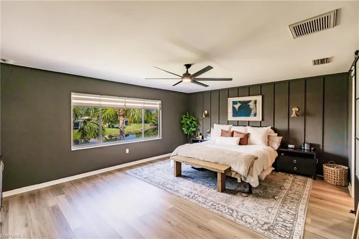 Bedroom with ceiling fan and light wood-type flooring