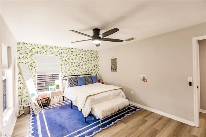 Bedroom featuring ceiling fan and hardwood / wood-style flooring