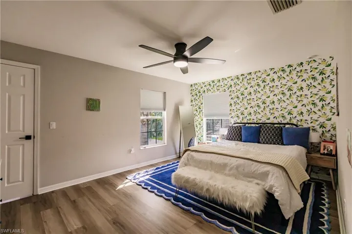 Bedroom featuring dark wood-type flooring and ceiling fan