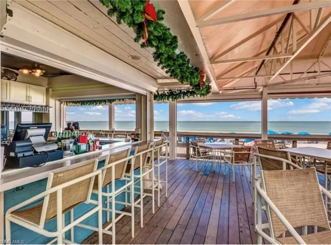 Wooden deck featuring a water view and an outdoor bar