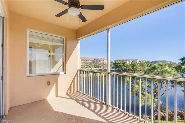 Calming balcony featuring ceiling fan and a water view.
