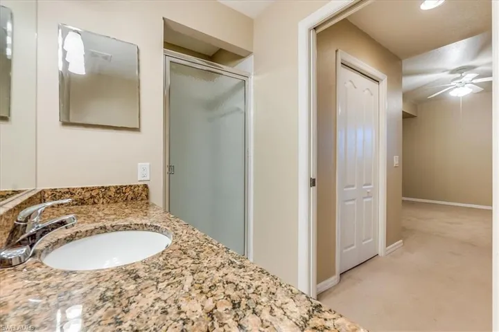 Primary bathroom featuring spacious vanity and walk-in shower.