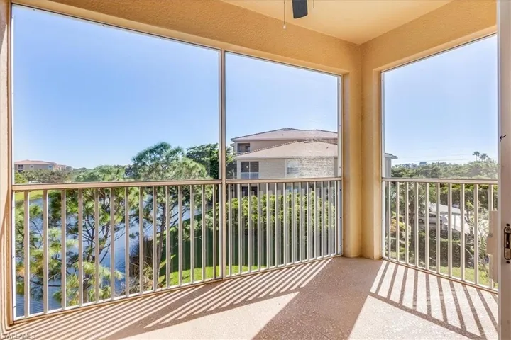 GORGEOUS end-unit, corner breeze & view from balcony featuring ceiling fan and a water view.