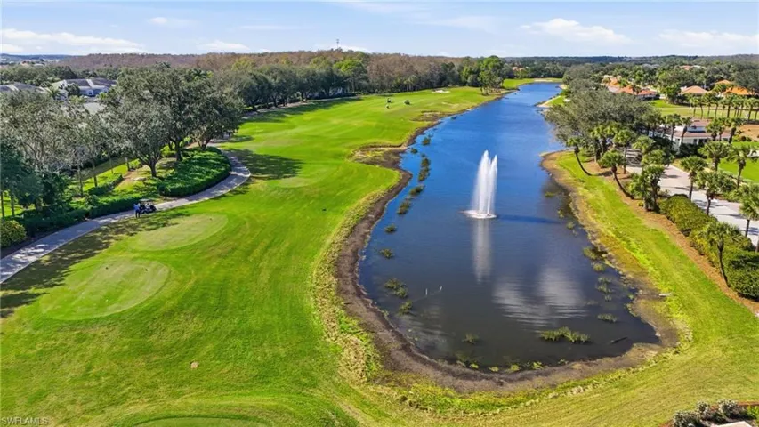 Drone / aerial view of a nearby body of water and a local golf course