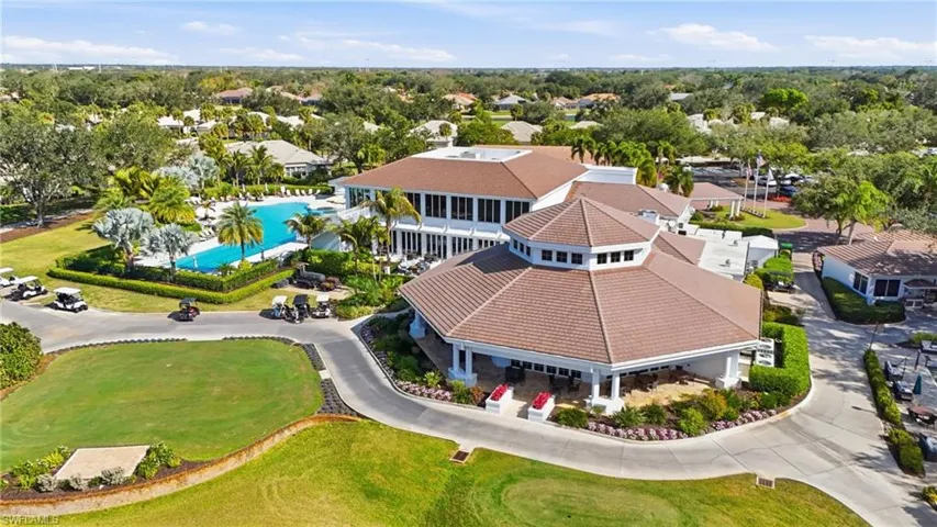 Drone / aerial view of a nearby body of water and a local golf course