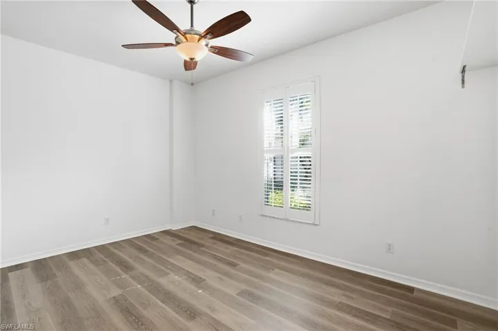 Empty room featuring wood finished floors and ceiling fan