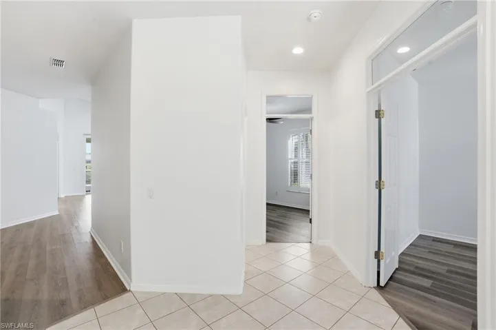 Hallway featuring light wood-style flooring and recessed lighting
