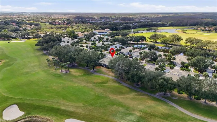 View of property location featuring a local golf course and nearby suburban area