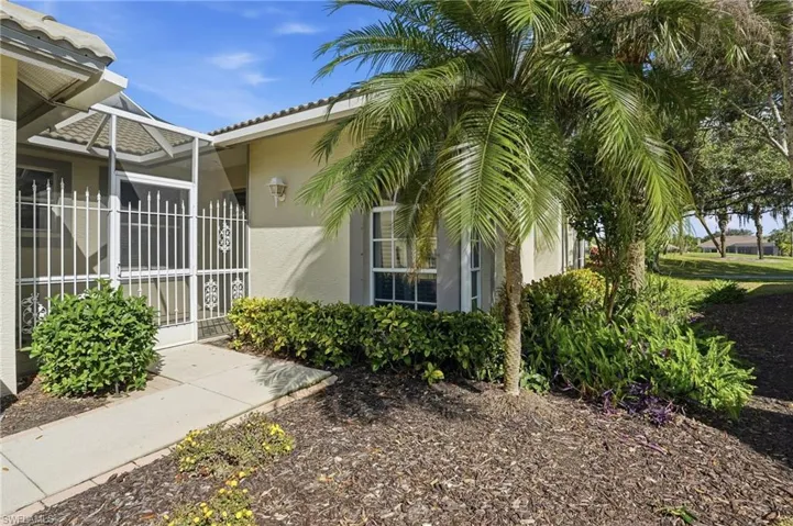 Entrance to property featuring stucco siding and a sunroom