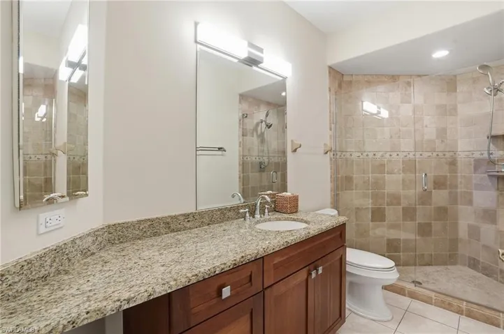 Bathroom featuring vanity, a stall shower, and light tile patterned flooring