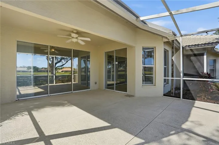 View of patio / terrace featuring a sunroom, glass enclosure, and ceiling fan