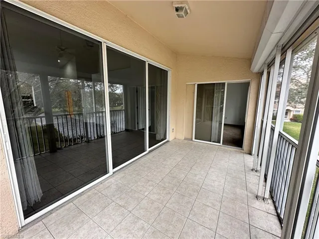 Lanai Sunroom featuring lovely sunlight and lofted ceiling with entrance to Living Room & Primary BR