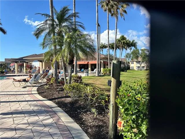View of community featuring a yard and a swimming pool