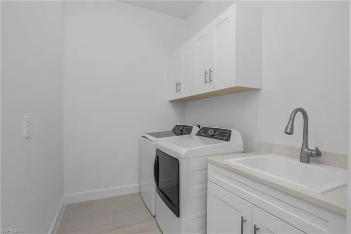 Laundry room featuring cabinet space and washer and dryer