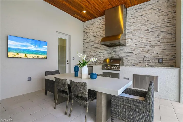 View of patio featuring an outdoor kitchen / dining area and a sink