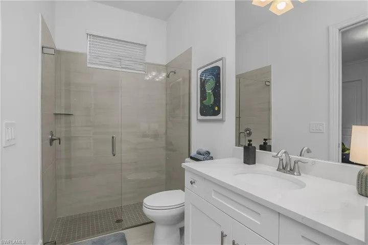 Full bath featuring vanity and a shower stall