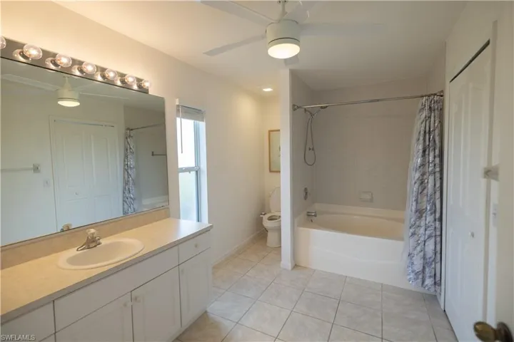 Full Master bathroom with a ceiling fan, vanity, shower / bath combo
