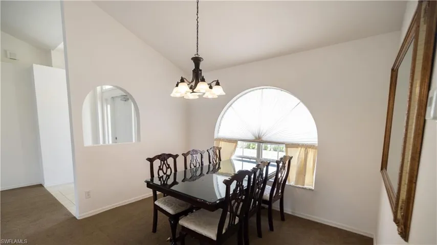 Dining area with a chandelier and vaulted ceiling