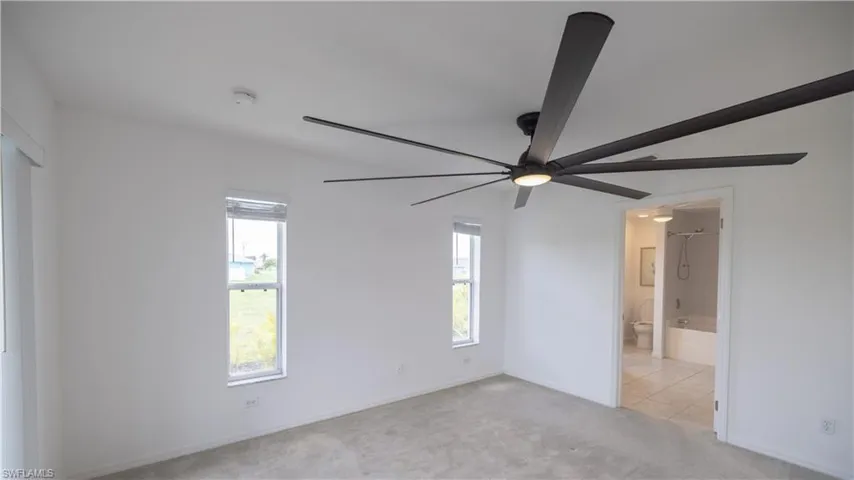 Master bedroom, ensuite bath, and ceiling fan