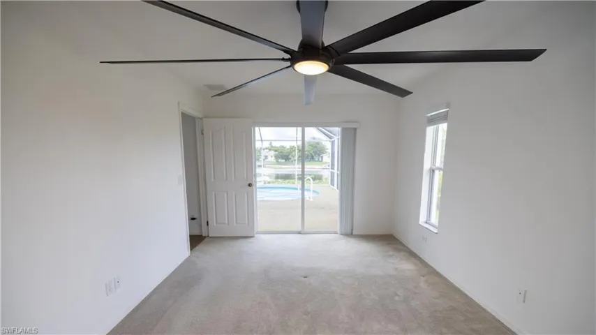 Master bedroom direct pool view, and a ceiling fan