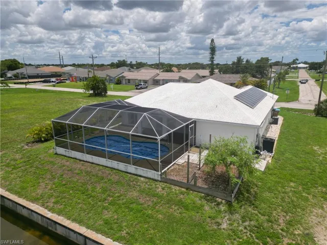 Bird's eye view of rear waterfront, and pool