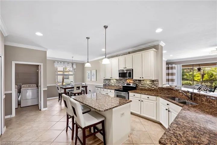 Oversized Kitchen with decorative backsplash, crown molding, laundry with new washer and dryer