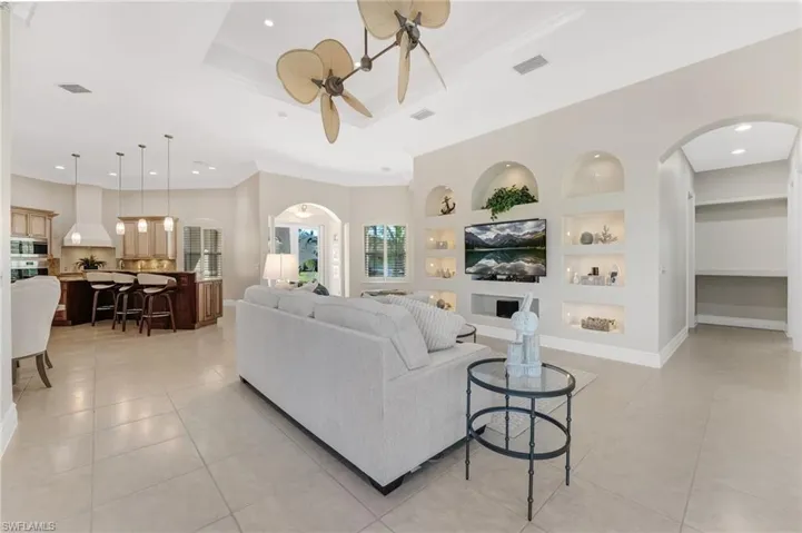 An open-concept design with custom built-ins creates a sophisticated yet inviting flow, perfectly suited for both grand-scale entertaining and intimate gatherings alike.
